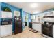 View of kitchen with black appliances and blue walls at 9431 E Coralbell Ave # 172, Mesa, AZ 85208
