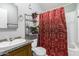 Bathroom with shower/tub combo and a red curtain at 9431 E Coralbell Ave # 172, Mesa, AZ 85208