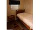 Cozy bedroom with a twin bed and wood nightstand at 2701 E Allred Ave # 68, Mesa, AZ 85204