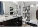 Bathroom with double sinks, a shower, and dark brown vanity at 10005 W Spur Dr, Peoria, AZ 85383