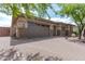 Front view of home with a two-car garage and brick facade at 10005 W Spur Dr, Peoria, AZ 85383