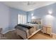 Serene bedroom with large windows and ceiling fan at 7710 E Gainey Ranch Rd # 133, Scottsdale, AZ 85258