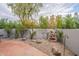 Landscaped backyard with stone pathway and water feature at 7710 E Gainey Ranch Rd # 133, Scottsdale, AZ 85258