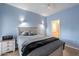 Bright bedroom with light wood furniture and ceiling fan at 7710 E Gainey Ranch Rd # 133, Scottsdale, AZ 85258