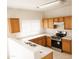 Efficient kitchen with wood cabinets and appliances at 9419 W Sheridan St, Phoenix, AZ 85037