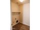 Small laundry room with wood-look flooring and shelving at 9419 W Sheridan St, Phoenix, AZ 85037