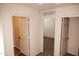 Bright hallway with doors leading to bedrooms and other rooms at 9419 W Sheridan St, Phoenix, AZ 85037