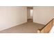 Spacious loft area with carpet and access to other rooms at 9419 W Sheridan St, Phoenix, AZ 85037