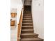 Carpeted staircase with wood railing at 9419 W Sheridan St, Phoenix, AZ 85037