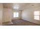 Bright living room with neutral carpeting and ample natural light at 9419 W Sheridan St, Phoenix, AZ 85037
