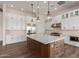 Modern kitchen with white cabinetry, a large island, and stainless steel appliances at 1606 E Minton St, Mesa, AZ 85203