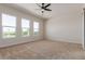 Spacious bedroom with three large windows, ceiling fan, and carpeted floors at 1606 E Minton St, Mesa, AZ 85203