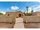 Front view of a charming house with arched entryway at 6023 E Turquoise Ave, Paradise Valley, AZ 85253