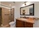 Well-appointed bathroom includes granite vanity, shower, and large mirror at 6023 E Turquoise Ave, Paradise Valley, AZ 85253