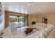 Bright living room featuring a large sectional sofa and access to the backyard patio at 6023 E Turquoise Ave, Paradise Valley, AZ 85253