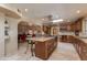 Open kitchen with granite island, custom cabinetry, and breakfast bar at 6023 E Turquoise Ave, Paradise Valley, AZ 85253