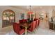 Bright dining room with large table and arched windows at 6023 E Turquoise Ave, Paradise Valley, AZ 85253