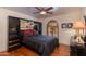 Bedroom with a full-size bed, built-in mirrored wardrobe, and ceiling fan at 6023 E Turquoise Ave, Paradise Valley, AZ 85253