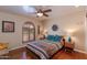 Bedroom with hardwood floors, southwestern bedding, ceiling fan, and arched window at 6023 E Turquoise Ave, Paradise Valley, AZ 85253