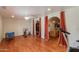 Home exercise room with wood floors and access to the living room at 6023 E Turquoise Ave, Paradise Valley, AZ 85253
