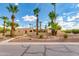 Front view of a beautiful house with palm trees and landscaping at 6023 E Turquoise Ave, Paradise Valley, AZ 85253