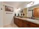 Double vanity bathroom with granite countertops and large mirror at 6023 E Turquoise Ave, Paradise Valley, AZ 85253