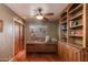 Home office with built-in wooden desk, shelving, and hardwood floors at 6023 E Turquoise Ave, Paradise Valley, AZ 85253