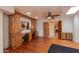 Home office with built-in wood desk and cabinets, hardwood floors, and ceiling fan at 6023 E Turquoise Ave, Paradise Valley, AZ 85253