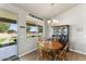 Cozy dining area with a wooden table and chairs, plus views of the backyard at 23612 W Beacon Ln, Wittmann, AZ 85361