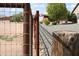 Rustic metal fence surrounds the property, offering privacy and security at 23612 W Beacon Ln, Wittmann, AZ 85361