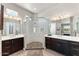 Double vanity bathroom with a large walk-in shower and modern fixtures at 23612 W Beacon Ln, Wittmann, AZ 85361