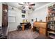 Home office with rolltop desk and built-in shelving at 38062 W San Capistrano Ave, Maricopa, AZ 85138