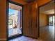 Entryway with wooden door and view to living area at 36601 N Mule Train Rd # A38, Carefree, AZ 85377