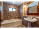 Bathroom with tile flooring, bathtub, pedestal sink, and decorative mirror at 36601 N Mule Train Rd # A38, Carefree, AZ 85377