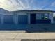 Modern two-car garage home with gray exterior and landscaped front yard at 5537 W Paseo Way, Laveen, AZ 85339