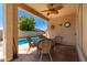 Relaxing patio with wicker furniture and pool view at 14623 W Hearn Rd, Surprise, AZ 85379