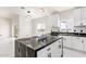 Modern kitchen with white cabinets, breakfast bar, and black countertops at 33 N 375Th Ave, Tonopah, AZ 85354