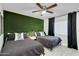 Guest bedroom with twin beds and a golf-themed accent wall at 8247 E Devonshire Ave, Scottsdale, AZ 85251