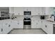 Modern kitchen featuring white cabinets, stainless steel appliances, and stylish backsplash at 8247 E Devonshire Ave, Scottsdale, AZ 85251