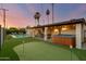 Expansive backyard with a pool, hot tub, and putting green at 8247 E Devonshire Ave, Scottsdale, AZ 85251
