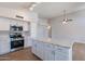 Open concept kitchen with white cabinets and island at 9859 W Potter Dr, Peoria, AZ 85382