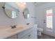 Double vanity bathroom with updated fixtures and a private door to exterior at 9859 W Potter Dr, Peoria, AZ 85382