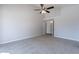 Spacious bedroom with carpet flooring, ceiling fan, and access to hallway at 9859 W Potter Dr, Peoria, AZ 85382