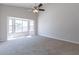 Bright bedroom with carpet flooring, ceiling fan, and window overlooking the pool at 9859 W Potter Dr, Peoria, AZ 85382