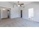 Large bedroom with carpet flooring, ceiling fan and access to bathroom and hallway at 9859 W Potter Dr, Peoria, AZ 85382