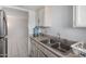 Kitchen with double sink, cabinets and view into living room at 7126 N 19Th Ave # 173, Phoenix, AZ 85021