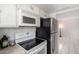 White cabinets, stove and view into dining area at 7126 N 19Th Ave # 173, Phoenix, AZ 85021
