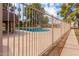 Community swimming pool area with surrounding fence and landscaping at 7126 N 19Th Ave # 173, Phoenix, AZ 85021
