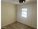Bedroom featuring a window, wood-look floors, and white walls at 7300 N 51St Ave # 160, Glendale, AZ 85301