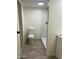 Bathroom with a shower, toilet, and wood-look floors at 7300 N 51St Ave # 160, Glendale, AZ 85301